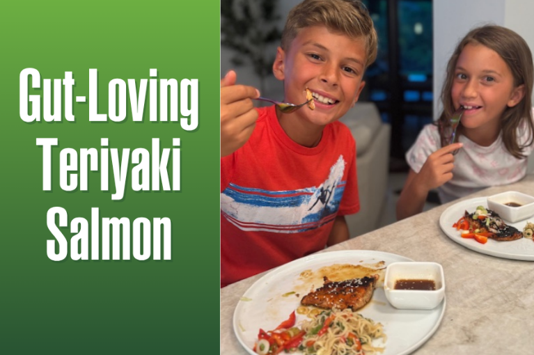 wo smiling kids enjoying gut-loving teriyaki salmon with noodles and veggies at the dinner table